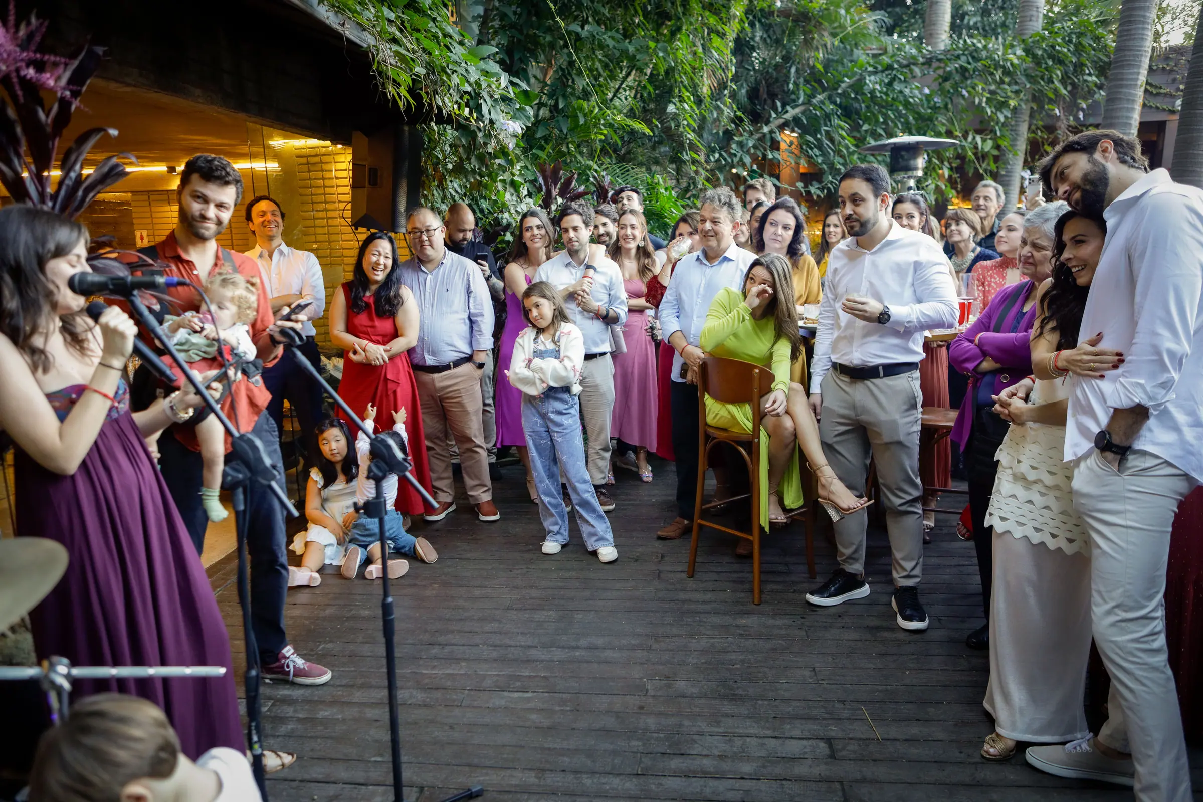 Momento da festa de casamento, convidados reunidos no espaço externo ao entardecer